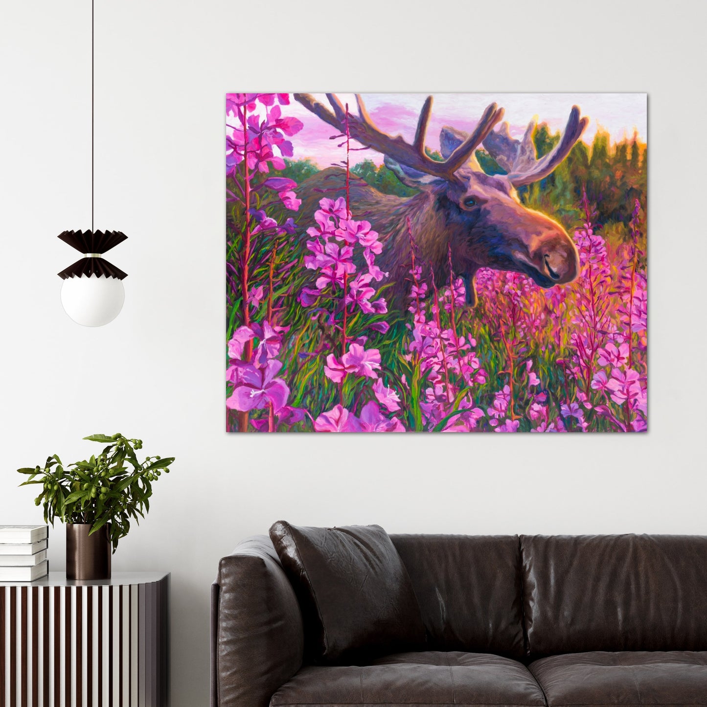 Vivid Fireweed and moose painting on wall above brown couch